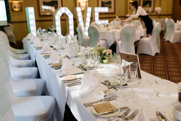 Wedding top table with large illuminated letters spelling LOVE