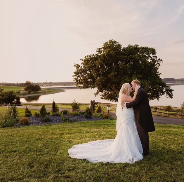 Wedded couple kiss by Blithfield Reservoir