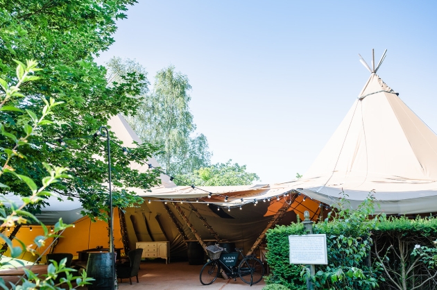 Barnsdale Gardens oak arbour set for wedding ceremony surrounded by colourful themed gardens