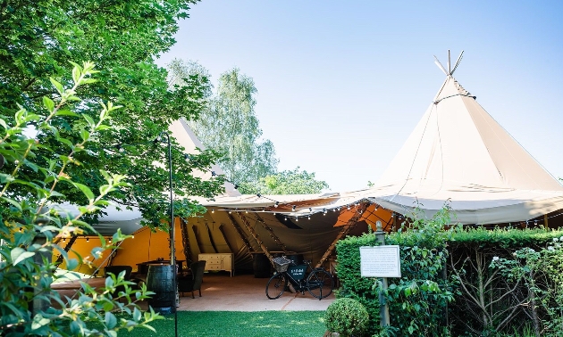 Outdoor wedding ceremony beneath the oak arbour at Barnsdale Gardens surrounded by themed gardens