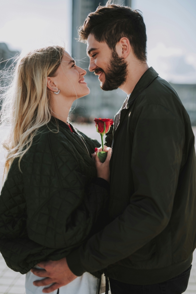 young couple standing together outside