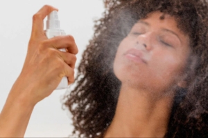 lady spaying spf on face